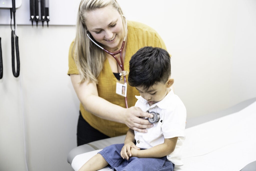 a young boy being examined by a doctor