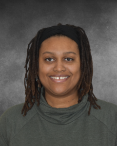 a woman with dreadlocks is smiling for a picture