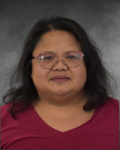 a woman wearing glasses and a red shirt