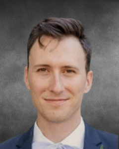 a man in a suit and tie smiling for a picture