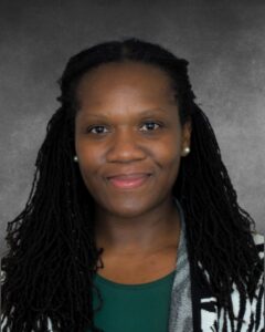 a woman with dreadlocks is smiling at the camera