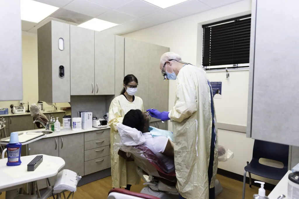 a man getting his teeth checked by a dentist