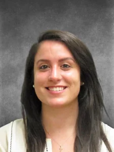a woman with long black hair smiling at the camera