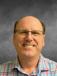a man wearing glasses and a plaid shirt