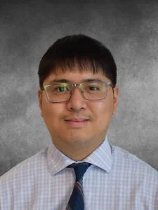 a man wearing glasses and a blue tie