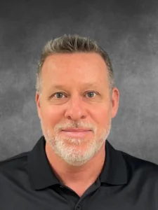 a man in a black shirt is posing for a photo