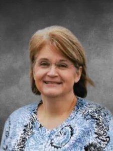 a woman with glasses and a blue shirt