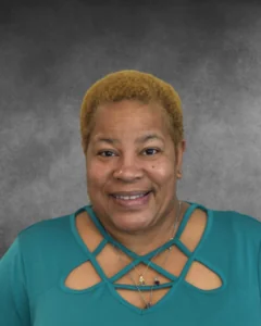 a woman with blonde hair wearing a green shirt