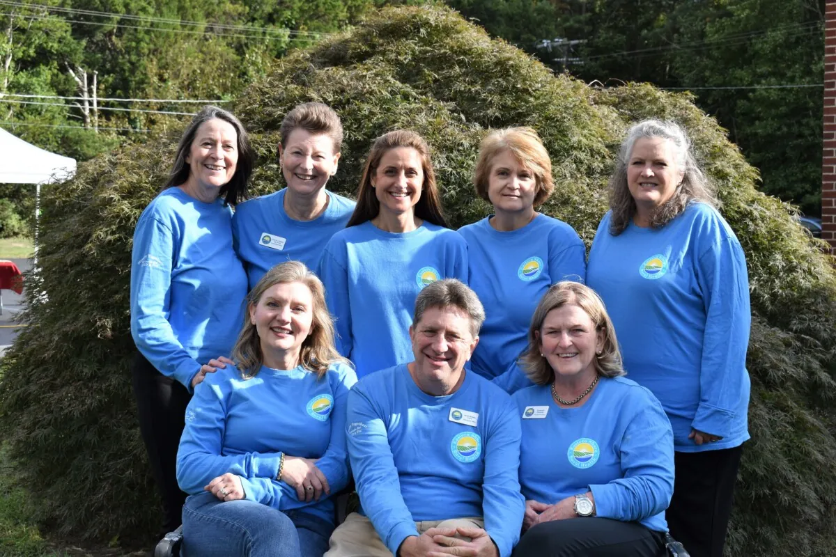 a group of women in blue shirts posing for a picture