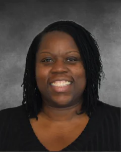 a woman with dreadlocks smiling for a picture