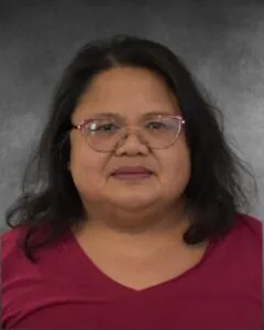 a woman wearing glasses and a red shirt